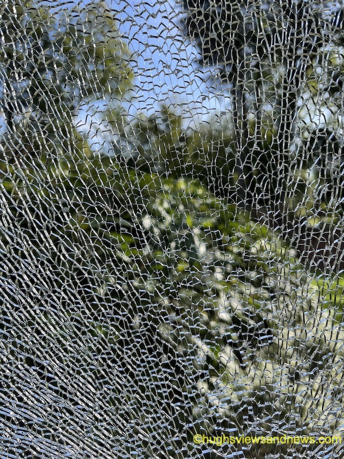 Photo of a window that has a shattered glass pane.